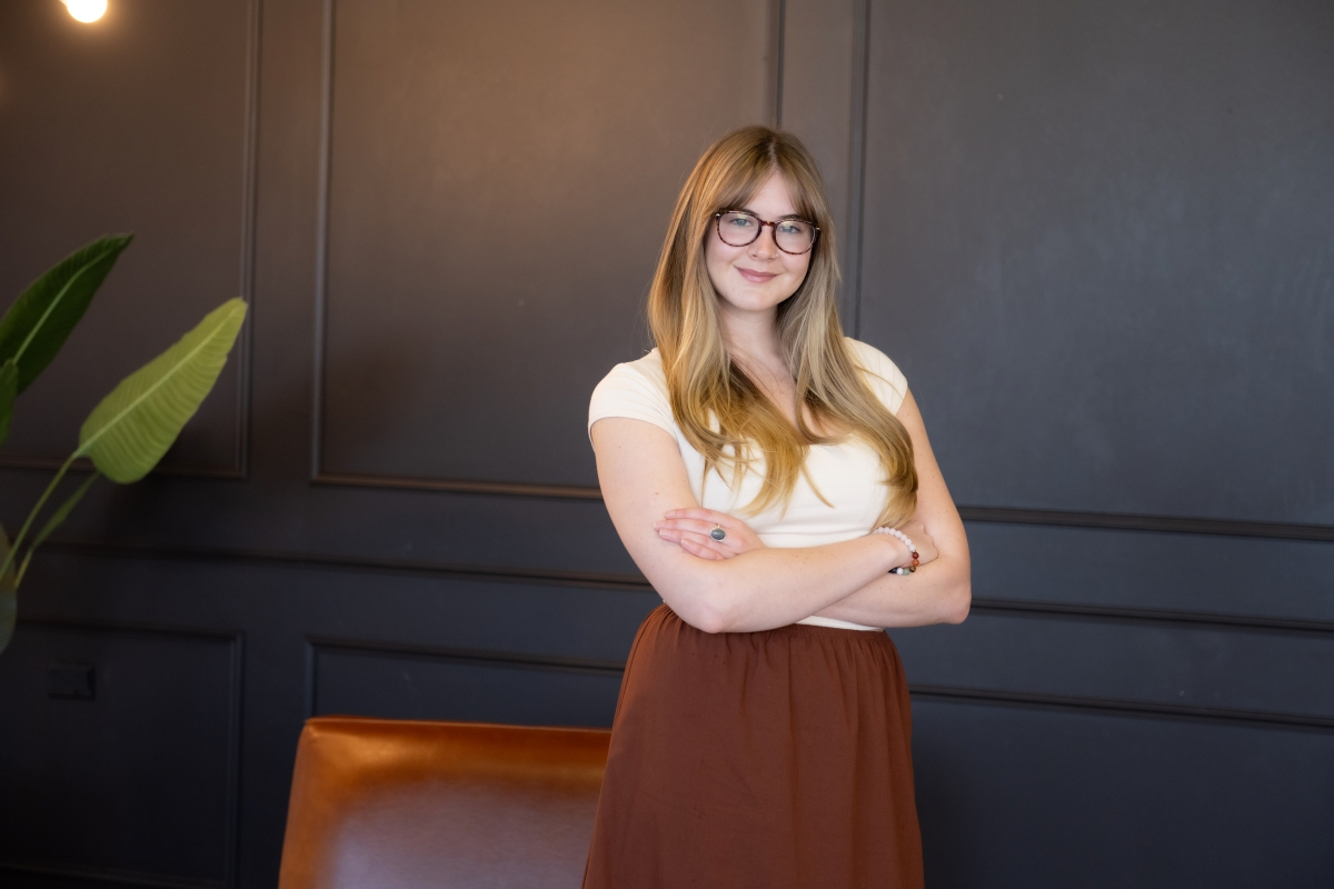 Woman standing confidently with arms crossed, symbolizing the empowerment of hiring a virtual assistant for business support