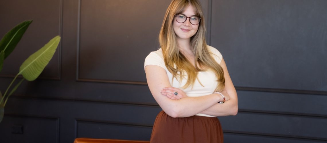 Woman standing confidently with arms crossed, symbolizing the empowerment of hiring a virtual assistant for business support